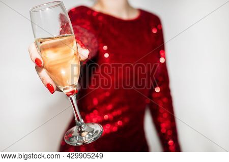 Christmas Cheer. Holiday Drink. Party Celebration. Festive Reeting Toast. Unrecognizable Woman Red P
