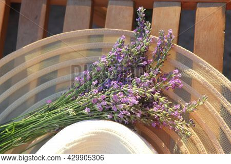 Summer Hat Over Lavender Flowers Against Sunlight