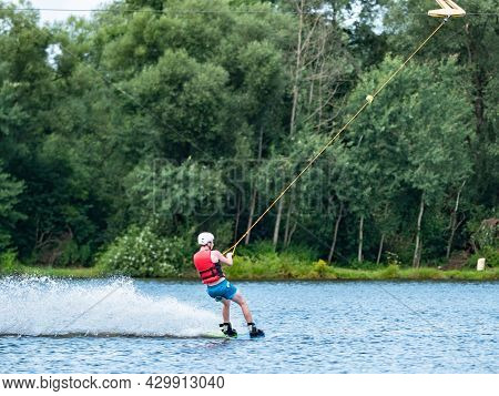 Straz, Czechia. 29th Of July, 2021. Man Wake Boarding On Lake In High Speed.
