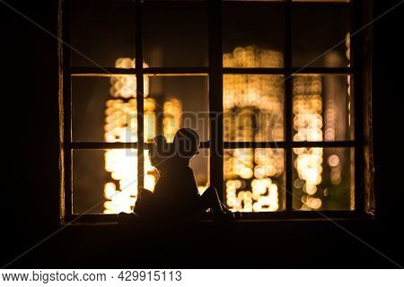 A Realistic Dollhouse Living Room With Furniture And Window At Night. Romantic Couple Sitting On Win
