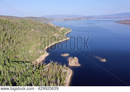 Aerial View Of Lake Granby, Colorado And Surrounding Mountains And Forests On Clear Calm Summer Morn