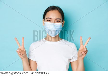 Covid-19, Social Distancing And Coronavirus Pandemic Concept. Cute Smiling Asian Girl In White T-shi