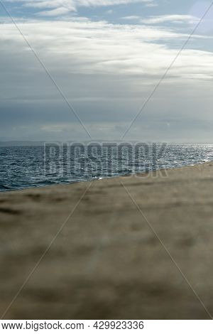 Blue Sky With Clouds And The Calm Sea Seen From The Ponta Do Humaitá Pier.