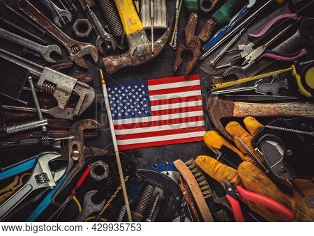 Patriotic collection of worn and used work tools with small US American flag. Made in USA, American workforce, or Labor Day concept.