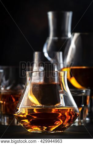Strong Alcohol Drinks, Hard Liquors, Spirits And Distillates Iset In Glasses: Cognac, Scotch, Whiske