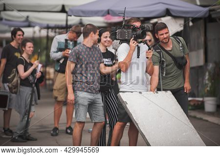 Behind The Scenes. Film Crew Team Shooting Movie Scene On Outdoor Location. Group Filmmaking Set Pro