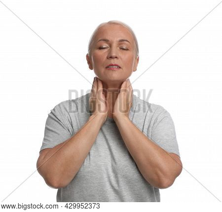 Mature Woman Doing Thyroid Self Examination On White Background