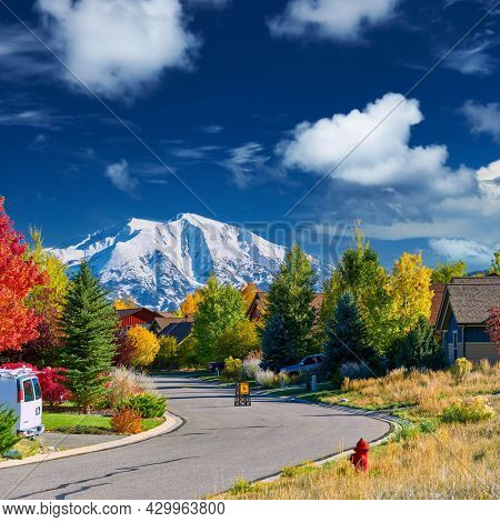 Slow children at play street sign at residential neighborhood in Colorado at autumn, USA. Mount Sopris landscape.