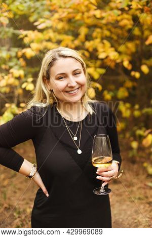 Blod Female In Black Dress Enjoying White Wine On Sunny Summer Day In Nature