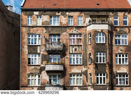 Shabby Cracked Building Facade, Old Windows. Front Facade Of Old Apartment Building In European City