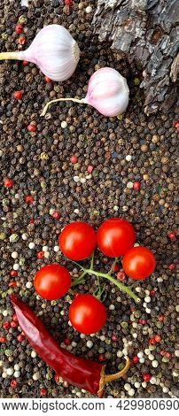 Ripe Ingredients For Cooking. Red Hot Chili Peppers, Cherry Tomatoes, Aromatic Garlic, Allspice Peas