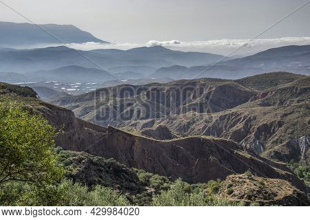 Alpujarra Landscape With Valleys, Ravines, Mountains And A Low Cloud In The Background