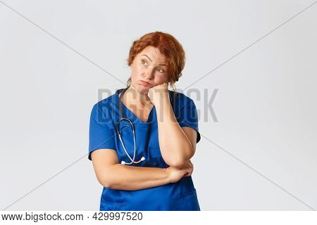 Medicine, Healthcare And Coronavirus Concept. Bored And Reluctant Redhed Middle-aged Doctor, Female 