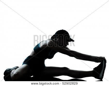 one caucasian woman runner jogger stretching legs warming up in silhouette studio isolated on white background