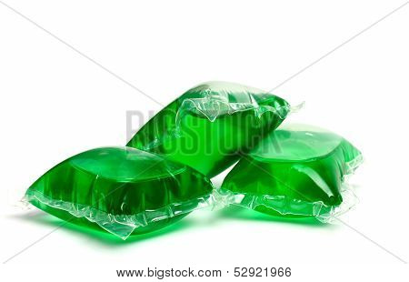 Three green laundry detergent capsules