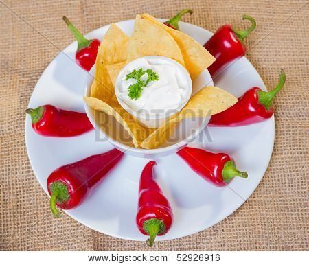 Sourcream With Corn Chips And Red Hot Chilli Peppers.