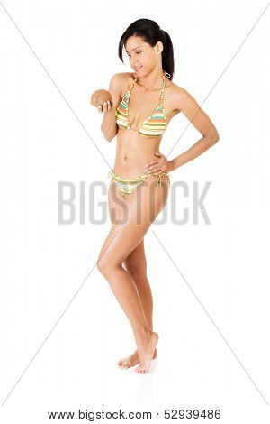 Beutiful, smiling woman in bikini with cocount, front body. Isolated on white.