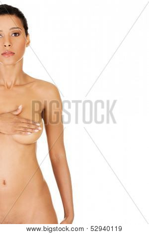 Young woman doing self brast examination, holdin her breasts.Isolated on white.