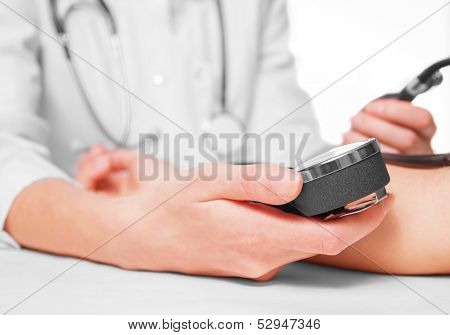 Doctor measures blood pressure