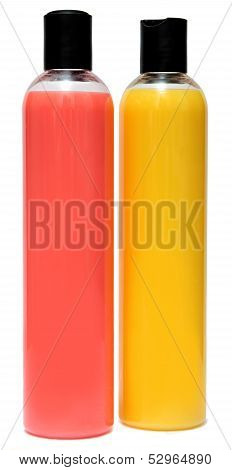 Two plastic bottles of shampoo or shower gel isolated on a white background.