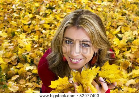 Beautiful woman with yellow leaves