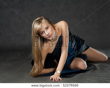 Beautiful model dressed in fabrick laying on floor