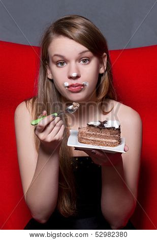 a Cheerful woman eating chocolade a pie