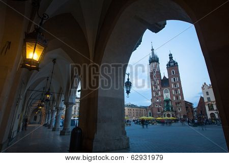 KRAKOW, POLAND - APR 7, 2014: St. Mary's Church on Rynek Glowny (Market Square) in night time. Rynek Glowny - roughly 40,000 m2 is largest medieval town square in Europe.