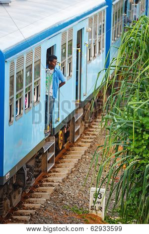 Bentota, Sri Lanka - 28 Apr 2013: Man Stay In A Door Of A Blue Train In Bentota, Sri Lanka. Trains A