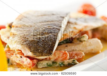 Fillet of Seabass with Tomato and Mussels Sauce. Garnished with Vegetables