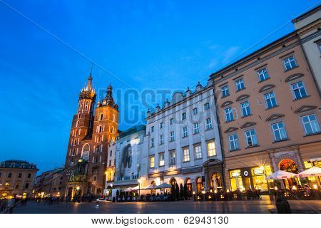 KRAKOW, POLAND - APR 7, 2014: St. Mary's Church on Rynek Glowny (Market Square) in night time. Rynek Glowny - roughly 40,000 m2 is largest medieval town square in Europe.