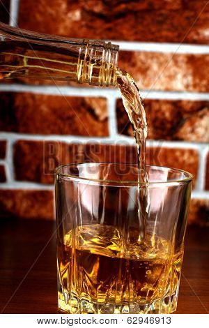 Luxury old whiskey glass on brick wall background