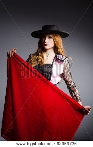 Redhead woman toreador against grey background