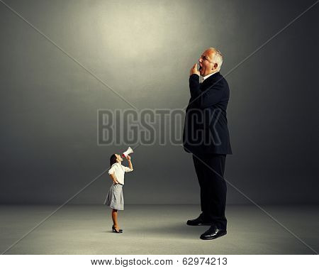 angry woman and big yawning boss over dark background