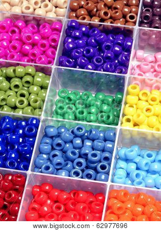 Closeup of beads in bins separated for making crafts jewelry