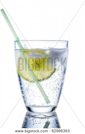 a glass of fresh drinking water and a lime. mineral water as a thirst quencher.