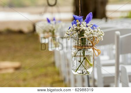 flowers hanging in mason jar at wedding