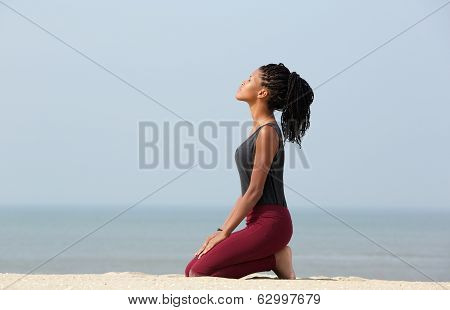 Woman Meditating At The Beach