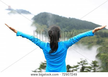 cheering hiking woman enjoy the beautiful view at mountain peak