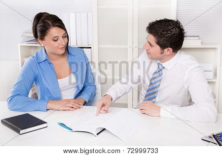 Teamwork - young business colleagues in a meeting discussing