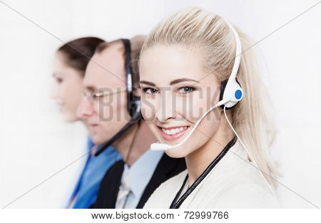 Telesales or helpdesk team - helpful woman with headset smling at camera