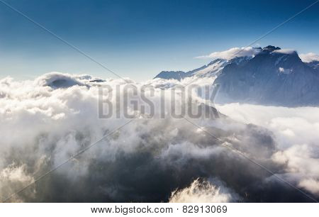 Great view of the foggy Val di Fassa valley with pass Sella. National Park. Dolomites (Dolomiti), South Tyrol. Location Canazei, Campitello, Mazzin. Italy, Europe. Dramatic scene. Beauty world.