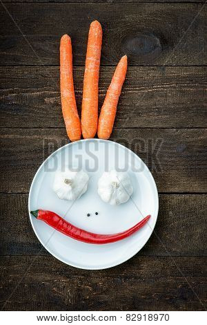 Smiley face made from pepper, garlic,flavoring and carrots
