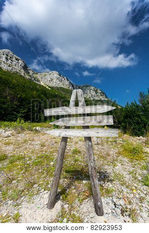 Wooden Signpost On Path To High Mountain