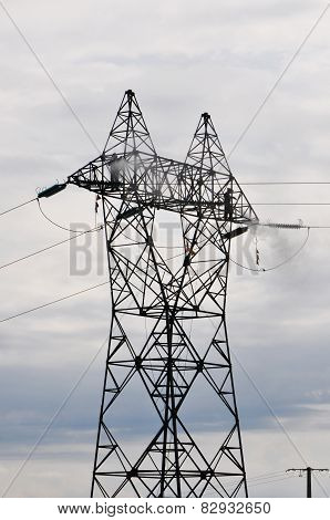 Two Guys Cleaning Big Electrical Pylon