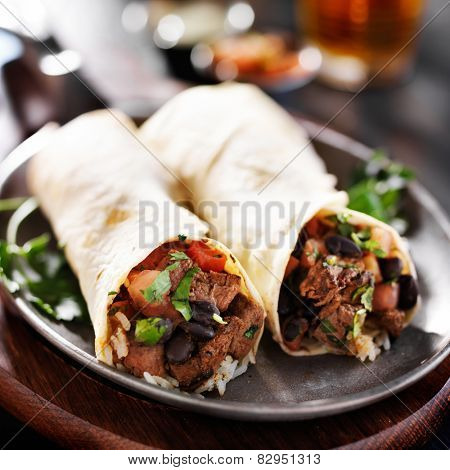 mexican beef steak burritos with black beans, rice, and salsa