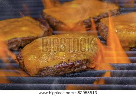 Cheeseburgers on a Hot Flaming Grill
