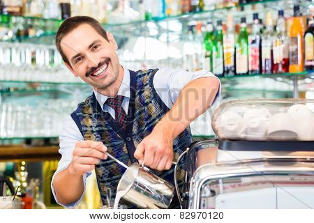 Barista in cafe or coffee bar preparing pouring espresso shot in glass of latte macchiato
