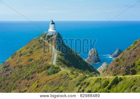 Lighthouse on Nugget Point. It is located in the Catlins area on the Southern Coast of New Zealand, Otago region. The Lighthouse is surrounded by small rock islands, nuggets