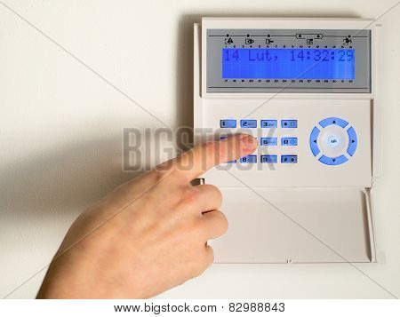 Pressing The Code On A House Alarm